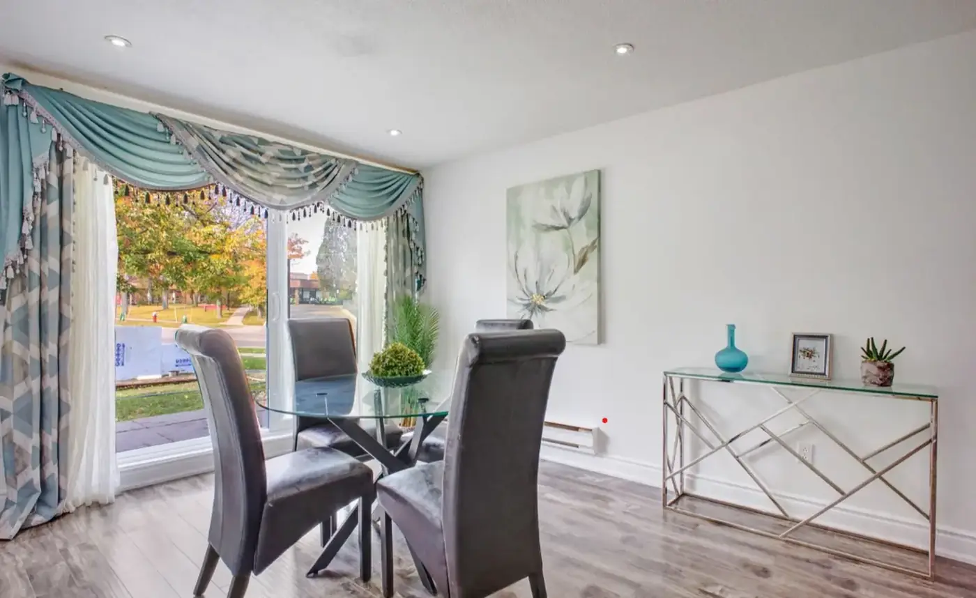 Bright dining area with a large window overlooking mature trees at 141-3040 Constitution Boulevard, Mississauga