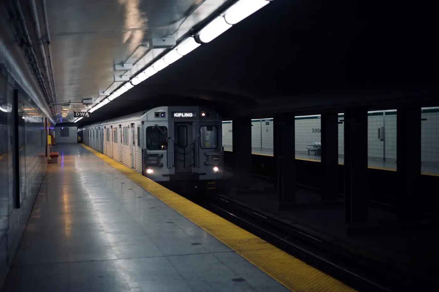 A subway train arriving at a station platform