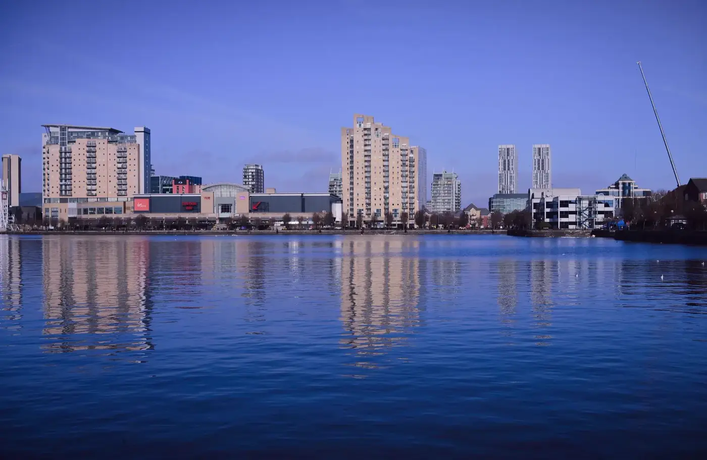 A modern city skyline reflected on calm water