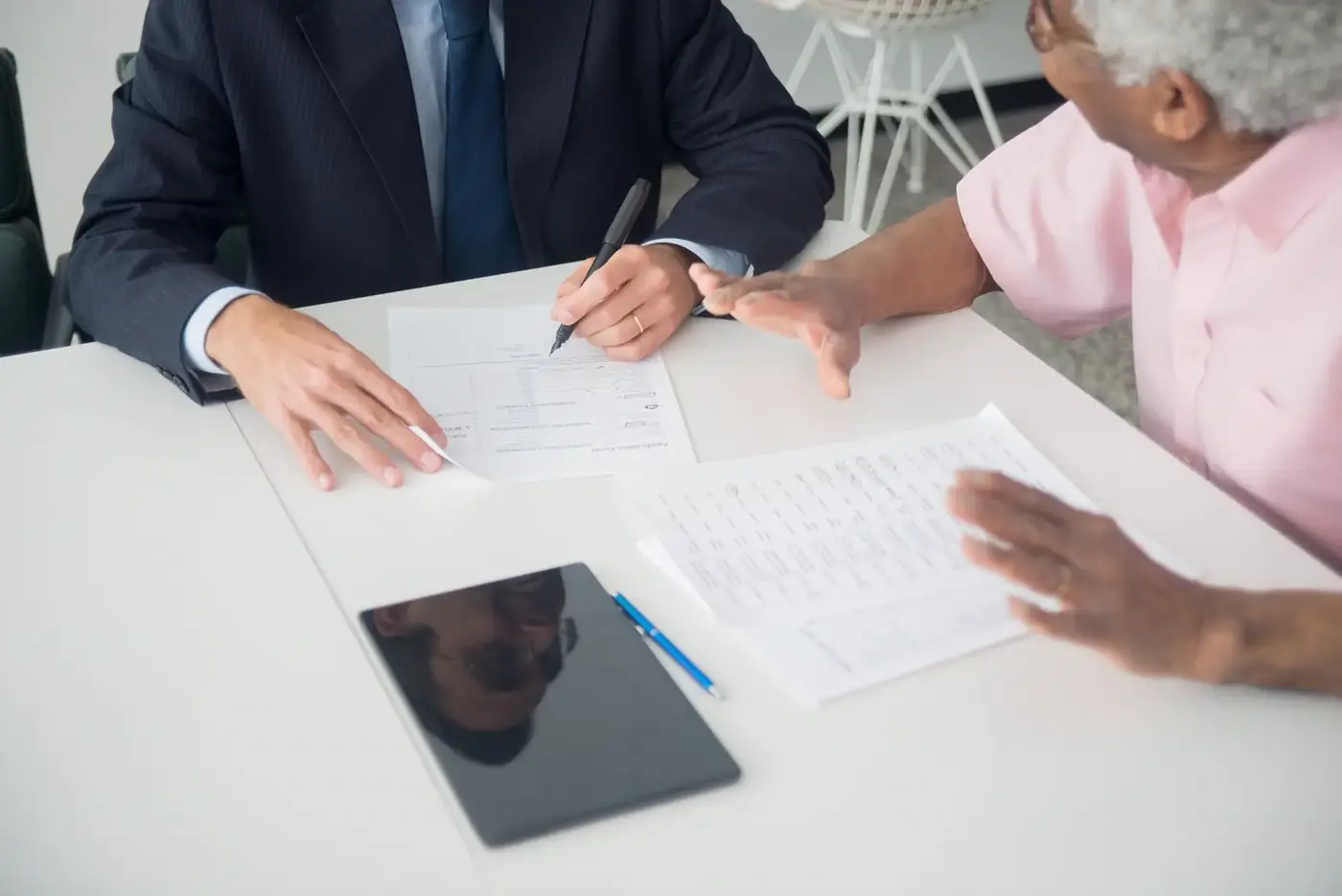 A consultant going through documents with an older client